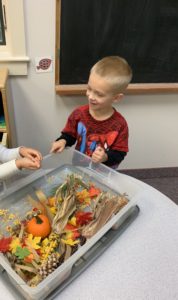 Playing with our fall sensory bin!